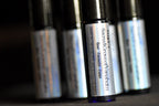 Roll-on bottles with labels on a dark background